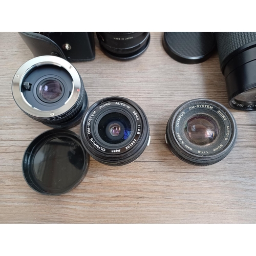 450 - A collection of camera lenses to include Olympus OM system Zuiko, cased Olympus OM system E.Zuiko au... 