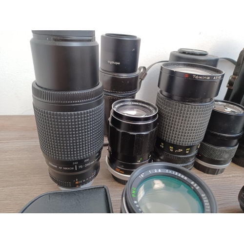 450 - A collection of camera lenses to include Olympus OM system Zuiko, cased Olympus OM system E.Zuiko au... 