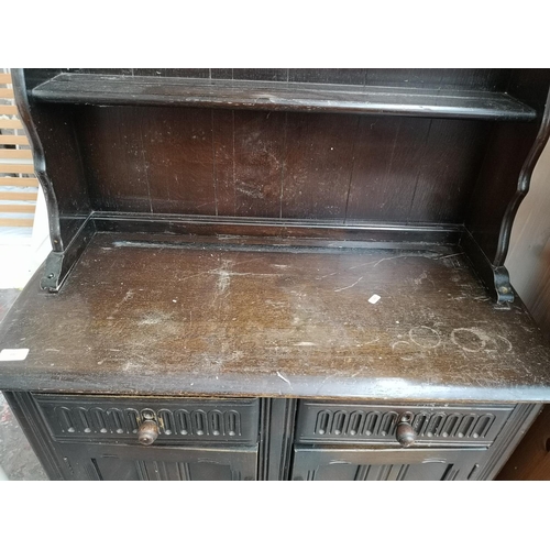 390 - An oak dresser with two drawers, two cupboard doors and upper plate rack