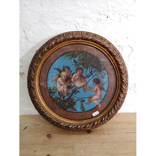 410 - An early 20th century gilt framed oil painting on oak panel of a cherub band signed lower left - app... 