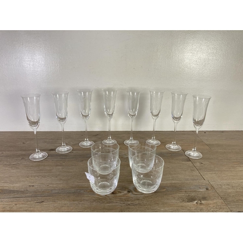 35 - Twelve pieces of etched glassware, eight 23cm champagne flutes and four tumblers