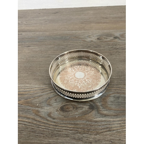 63 - Five silver plated bottle coasters - largest approx. 14cm diameter