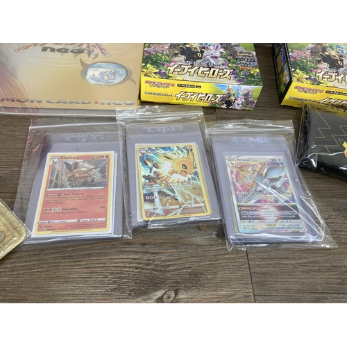 91 - A collection of Pokémon trading cards and accessories