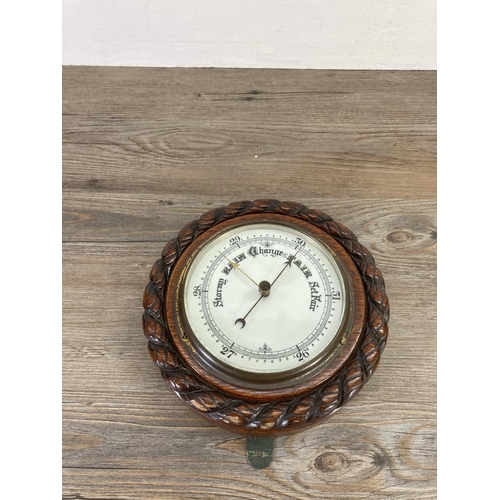 189 - An early 20th century oak cased barometer - approx. 20cm diameter