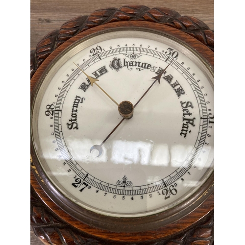 189 - An early 20th century oak cased barometer - approx. 20cm diameter