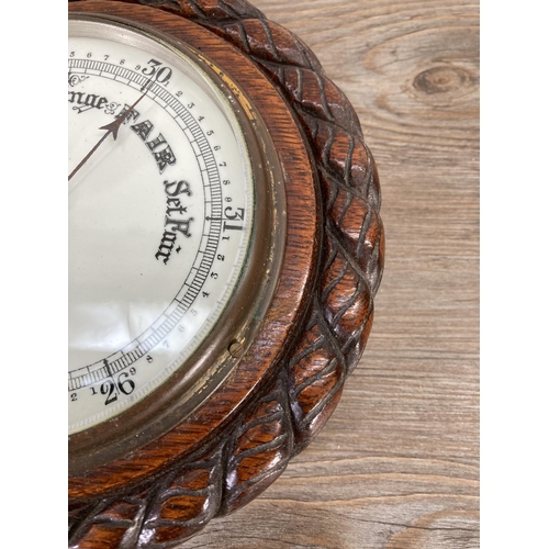 189 - An early 20th century oak cased barometer - approx. 20cm diameter