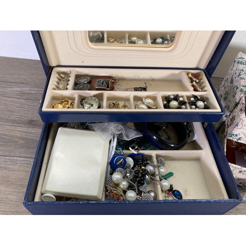 116 - Two boxes containing costume jewellery to include earrings, brooches etc.