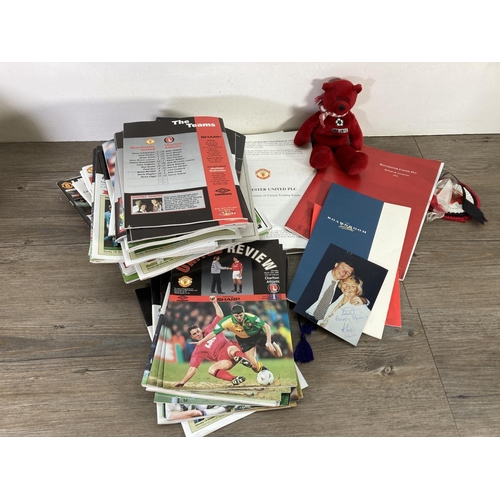 173 - A collection of Manchester United Football Club memorabilia to include signed photograph, United Rev... 