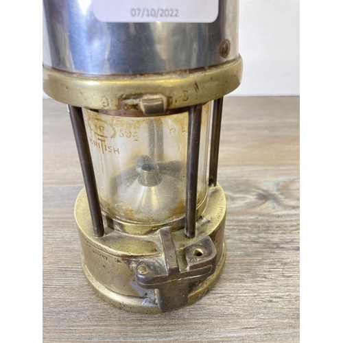 196 - An early 20th century brass and steel miner's lamp - approx. 24cm high