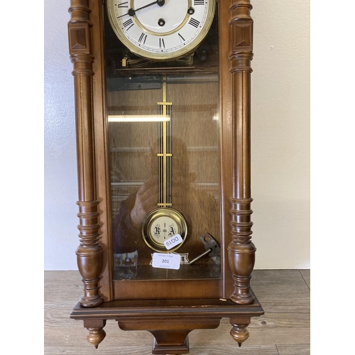 201 - A Hermle mahogany cased wall clock with pendulum and key