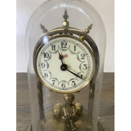 202 - A Schatz brass anniversary clock with glass dome - approx. 23cm high