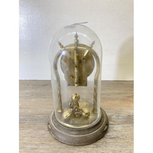 202 - A Schatz brass anniversary clock with glass dome - approx. 23cm high