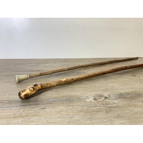 212 - Two vintage walking canes, one with white metal top and one with carved dog head top