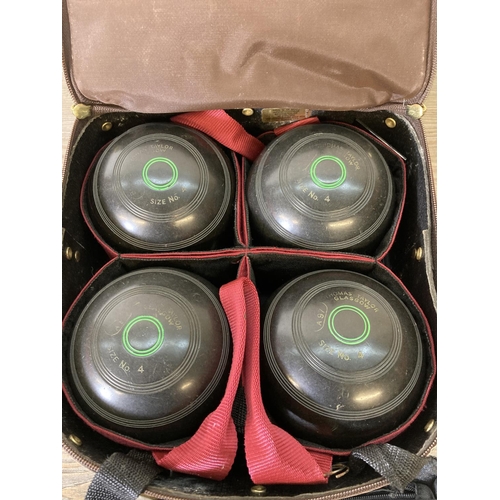 230 - A Thomas Taylor bowls bag containing four Thomas Taylor size no. 4 crown green bowls and accessories