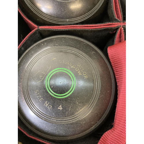 230 - A Thomas Taylor bowls bag containing four Thomas Taylor size no. 4 crown green bowls and accessories