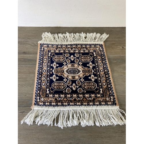 234 - A Moroccan acrylic and viscose prayer mat - approx. 35cm x 35cm