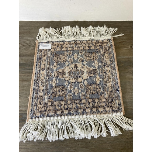 234 - A Moroccan acrylic and viscose prayer mat - approx. 35cm x 35cm