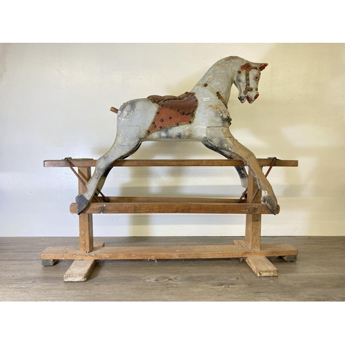 235 - A mid 20th century hand painted wooden rocking horse on beech stand - approx. 79cm high x 33cm wide ... 