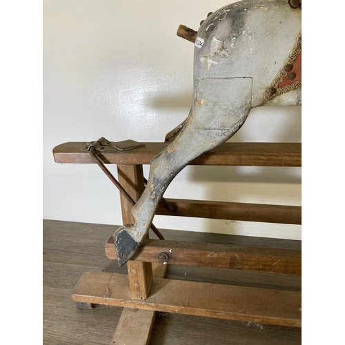 235 - A mid 20th century hand painted wooden rocking horse on beech stand - approx. 79cm high x 33cm wide ... 