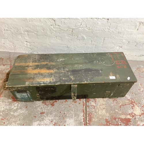 238 - A vintage military green painted wooden crate with shovel - approx. 25cm high x 88cm wide x 30cm dee... 