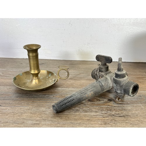 60 - Eight pieces of metalware to include brass chamberstick, Victorian brass preserve pan, four blow tor... 