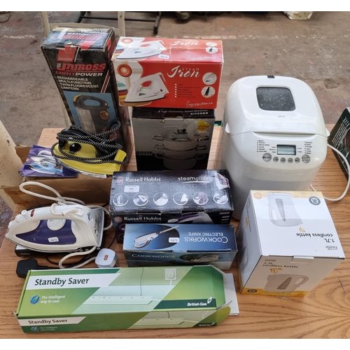 613 - A collection of electrical items to include boxed Russell Hobbs steam iron, boxed electric knife, bo... 