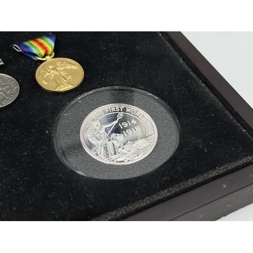 1302 - Three coins set to include cased 2014 First World War Centenary silver coin & medal collection compr... 