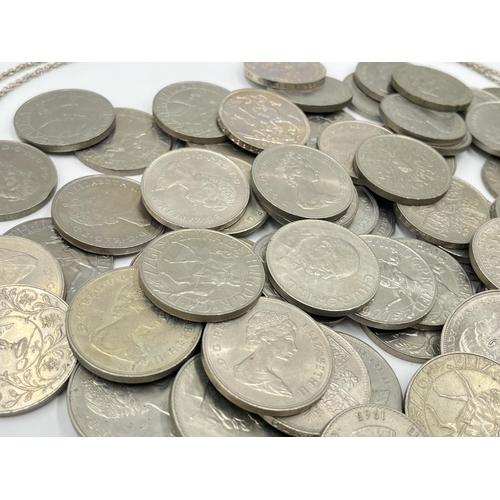 1303 - A large collection of mostly British commemorative coins to include 25 pence, five shillings etc.