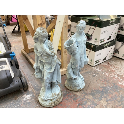 710 - Two cast stone garden ornaments in the form of ladies - largest approx. 70cm high