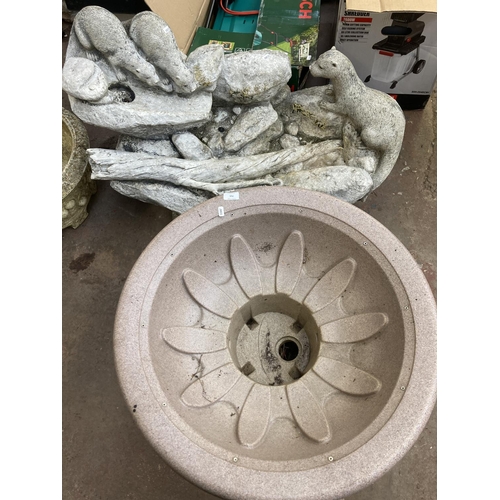 715 - Two garden items, one plastic water feature pedestal base and one fibreglass water feature in the fo... 