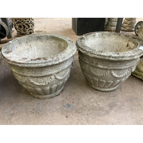 722 - A pair of cast stone garden planters - approx. 30cm high x 40cm diameter