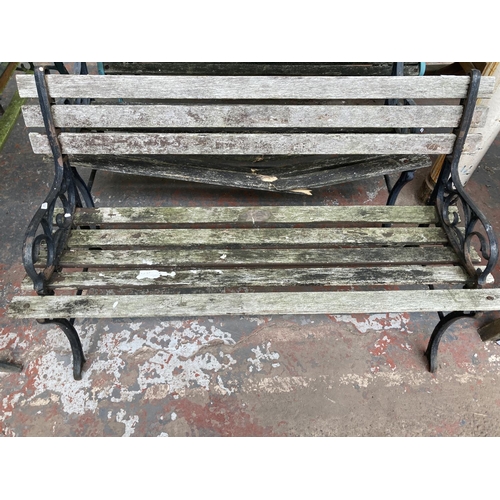 726 - Three cast iron and wooden slatted garden benches