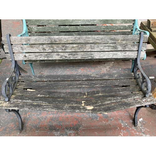 726 - Three cast iron and wooden slatted garden benches