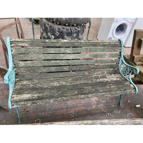 726 - Three cast iron and wooden slatted garden benches