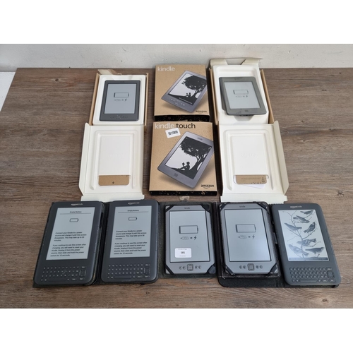 585 - Seven Amazon Kindle E-readers, five cased and two boxed