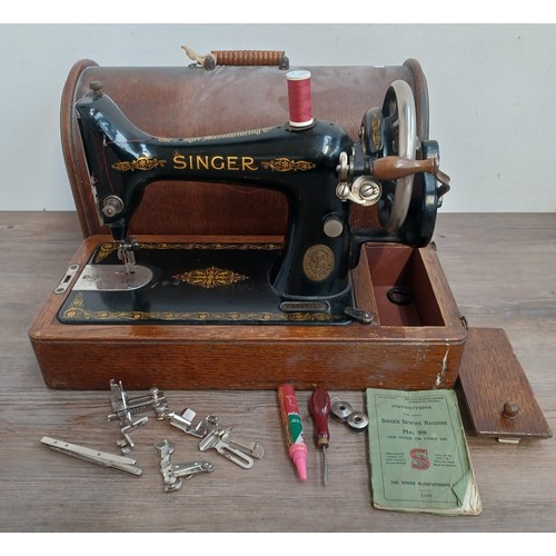 1546 - A cased c.1917 Singer No. 99 hand crank sewing machine with attachments and instruction manual - ser... 