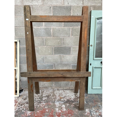 1006 - An early 20th century beech artist's easel - approx. 192.5cm high x 130cm wide x 67cm deep