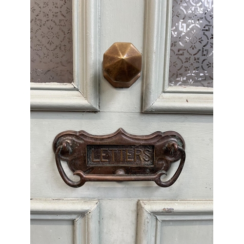 1007 - A green painted pine door with brass letterbox and handle - approx. 201cm high x 81cm wide