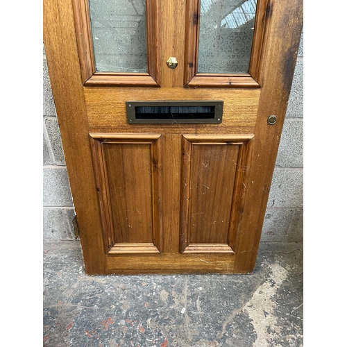 1007 - A green painted pine door with brass letterbox and handle - approx. 201cm high x 81cm wide