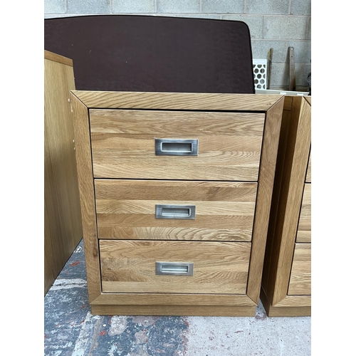 1014 - A pair of modern oak bedside chests of three drawers - approx. 62cm high x 47cm wide x 38cm deep