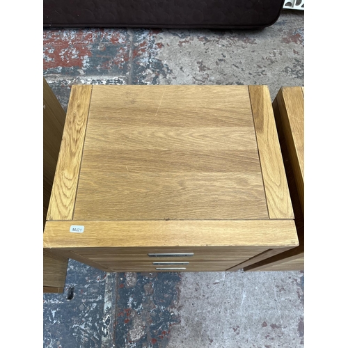 1014 - A pair of modern oak bedside chests of three drawers - approx. 62cm high x 47cm wide x 38cm deep