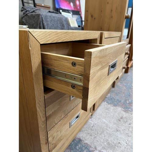 1014 - A pair of modern oak bedside chests of three drawers - approx. 62cm high x 47cm wide x 38cm deep