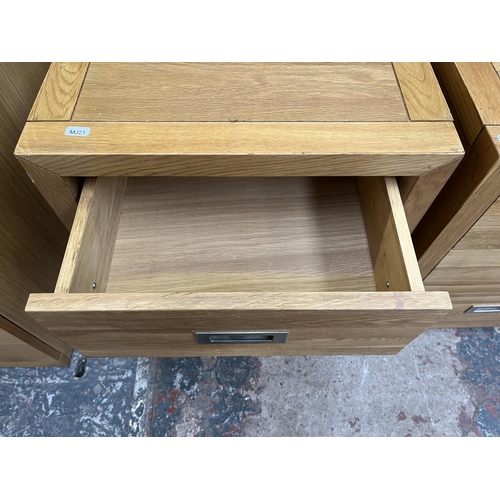 1014 - A pair of modern oak bedside chests of three drawers - approx. 62cm high x 47cm wide x 38cm deep