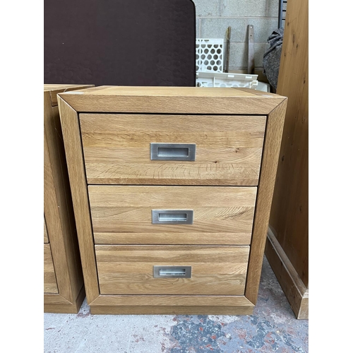 1014 - A pair of modern oak bedside chests of three drawers - approx. 62cm high x 47cm wide x 38cm deep