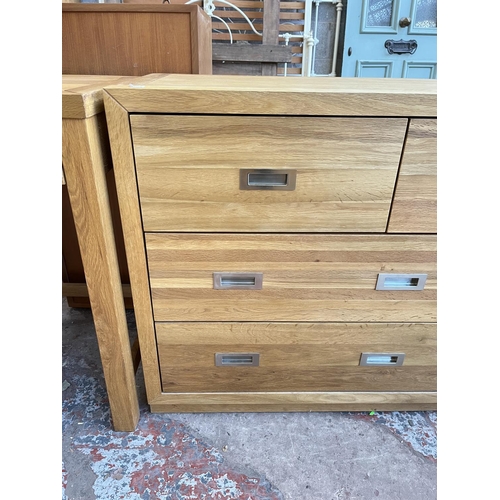 1018 - A modern oak chest of three short and four long drawers - approx. 76cm high x 145cm wide x 42cm deep