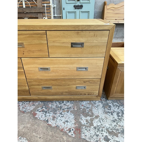 1018 - A modern oak chest of three short and four long drawers - approx. 76cm high x 145cm wide x 42cm deep