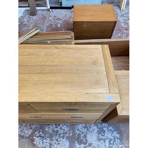 1018 - A modern oak chest of three short and four long drawers - approx. 76cm high x 145cm wide x 42cm deep