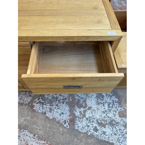 1018 - A modern oak chest of three short and four long drawers - approx. 76cm high x 145cm wide x 42cm deep