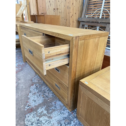 1018 - A modern oak chest of three short and four long drawers - approx. 76cm high x 145cm wide x 42cm deep