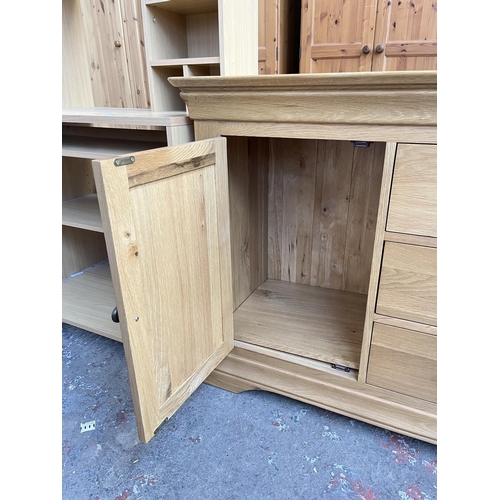 1021 - A modern solid oak sideboard with three central drawers and two outer cupboard doors - approx. 85cm ... 